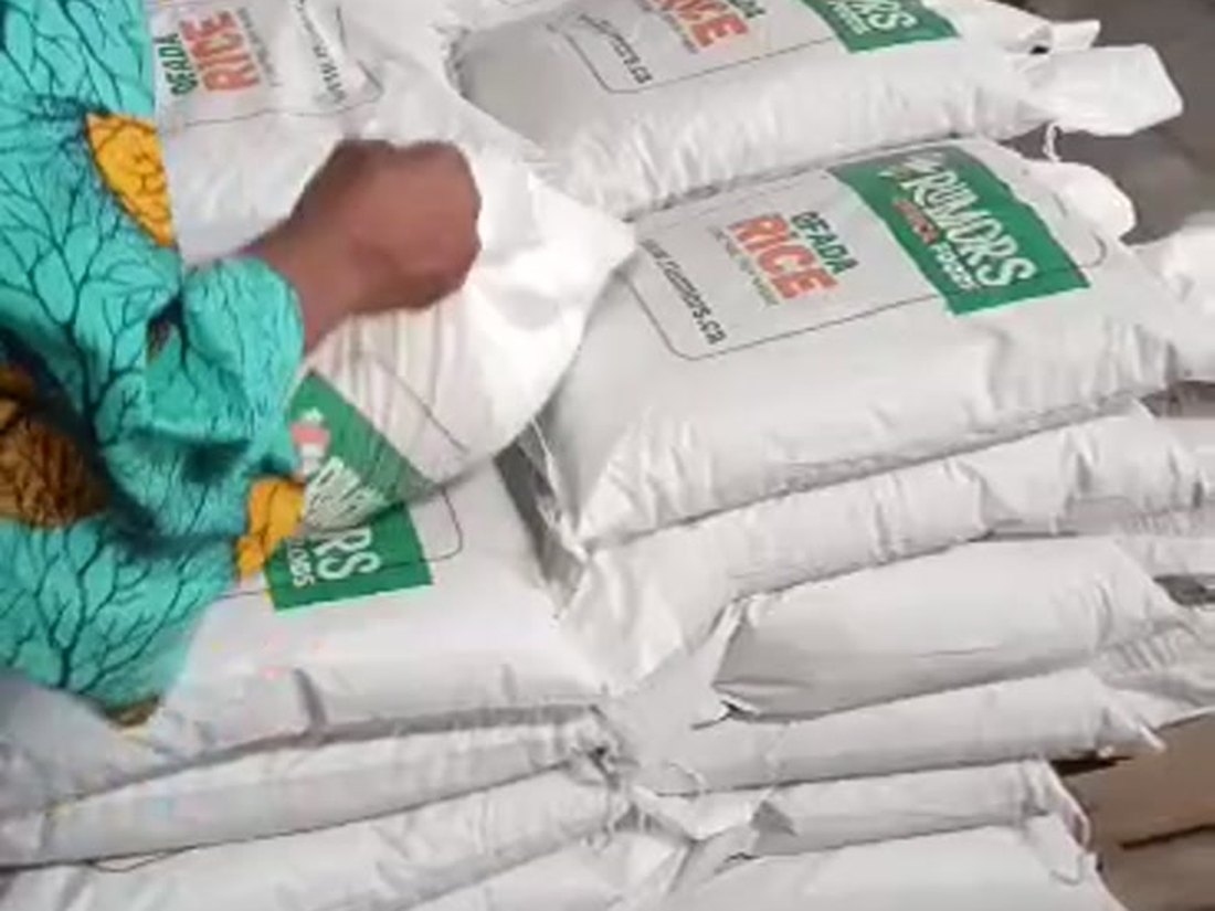 Staff stacking and checking sacks on the packing floor